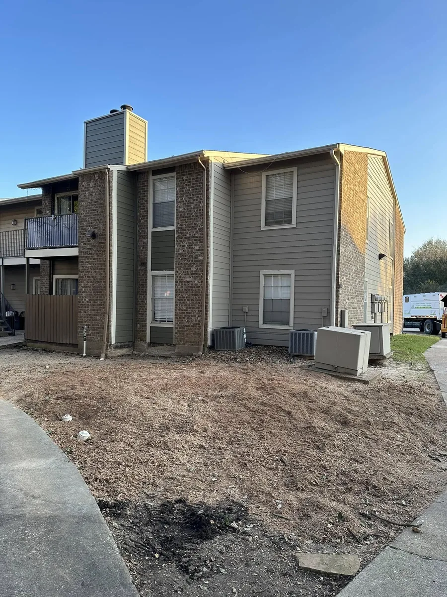 Apartment yard cleared after large oak tree removal